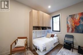 Toronto (Kensington-Chinatown) apartment for rent - A modern kitchen with wooden chairs and a refrigerator.
