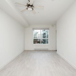Surrey apartment for rent - A room with a ceiling fan and a window.