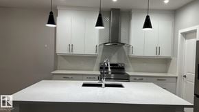Edmonton apartment for rent - A modern kitchen with a large island and pendant lights.