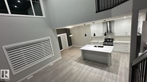 Edmonton apartment for rent - A modern kitchen with a white table and cabinets.