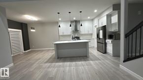 Edmonton apartment for rent - A modern kitchen with a center island and stainless steel appliances.