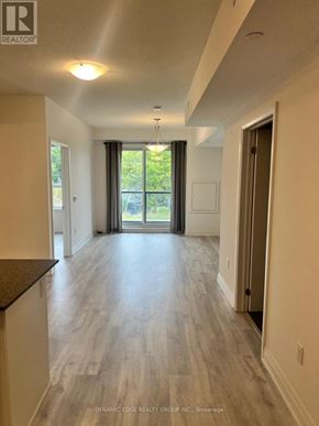 Markham (Greensborough) condo for rent - A spacious room with a sliding glass door leading to a balcony.