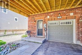 Wasaga Beach townhouse for rent - A house with a garage door and a brick wall.