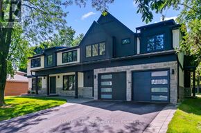 Oakville (Fd Ford) apartment for rent - A modern house with a black roof and a large driveway.