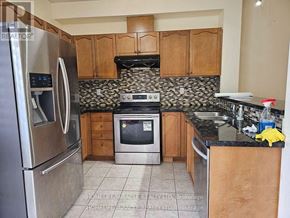 Brampton (Bram West) apartment for rent - A kitchen with a black and white tiled backsplash.