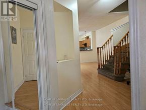 Brampton (Bram West) apartment for rent - A hallway with a staircase and a door on the left.