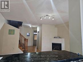 Brampton (Bram West) apartment for rent - A living room with a fireplace and a sign that says "Live Love".