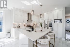 Woodstock (Woodstock - North) apartment for rent - A modern kitchen with white cabinets and a central island.