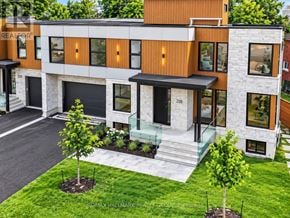 Ottawa apartment for rent - A modern house with a brown and white exterior and a glass door.
