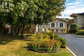 Newmarket (Gorham-College Manor) apartment for rent - A house with a well-maintained lawn and a flower bed in front.