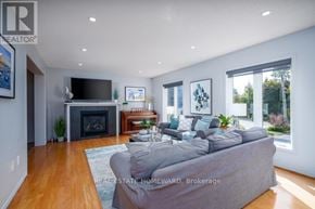 Newmarket (Gorham-College Manor) apartment for rent - A living room with a grey couch and a fireplace.
