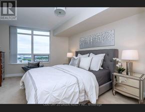Mississauga (City Centre) condo for rent - A bedroom with a large bed and a window overlooking the city.