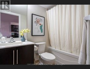 Mississauga (City Centre) condo for rent - A bathroom with a toilet, sink, and a painting on the wall.