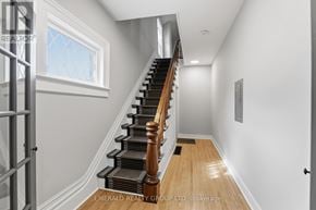 Thorold (Thorold Downtown) apartment for rent - A staircase with wooden steps and a metal railing.