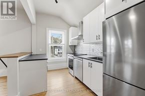 Thorold (Thorold Downtown) apartment for rent - A modern kitchen with stainless steel appliances and white cabinets.
