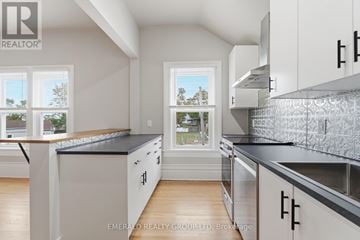 Thorold (Thorold Downtown) apartment for rent - A kitchen with white cabinets and a black countertop.