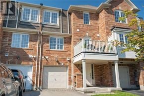 Milton (Co Coates) townhouse for rent - A brick apartment building with a balcony on the second floor.