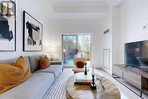 Vaughan (Lakeview Estates) condo for rent - A modern living room with a grey sofa and a coffee table in the center.