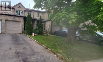 Richmond Hill (Observatory) townhouse for rent - A house with a garage and a tree in front of it.