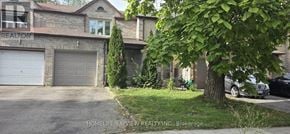 Richmond Hill (Observatory) townhouse for rent - A house with a garage and a tree in front of it.