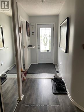 Richmond Hill (Observatory) townhouse for rent - A hallway with a door and a mat on the floor.
