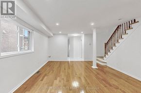 Mississauga (East Credit) apartment for rent - A spacious room with wooden flooring and white walls.