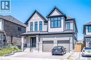 Kitchener apartment for rent - A modern house with a grey facade and a black car parked in front.