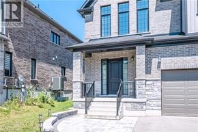 Kitchener apartment for rent - A house with a stone facade and a black door.
