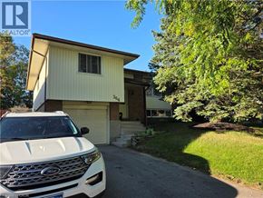 Waterloo apartment for rent - A white car is parked in front of a house with a garage.