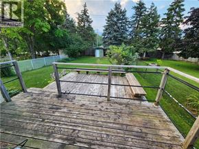 Waterloo apartment for rent - A wooden deck with a railing and a bench.
