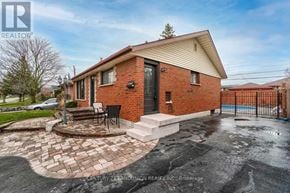 Oshawa (Mclaughlin) apartment for rent - A brick house with a black gate and a brick patio.