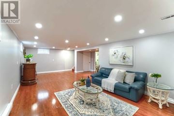 Oshawa (Mclaughlin) apartment for rent - A living room with a blue couch and a rug on the floor.