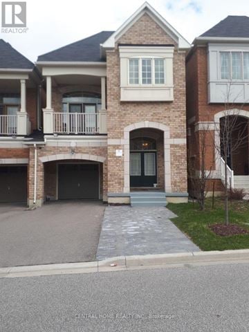 Vaughan (Patterson) apartment for rent - A brick house with a black door and a balcony.