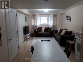 Vaughan (Patterson) apartment for rent - A living room with a couch, chairs, and a television.