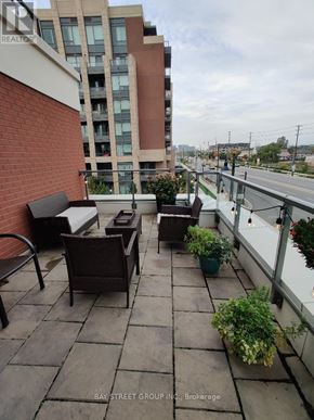Markham (Unionville) condo for rent - A patio with a table and chairs overlooking a street.