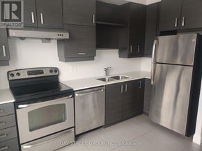 Markham (Unionville) condo for rent - A modern kitchen with a stainless steel refrigerator, oven, and sink.