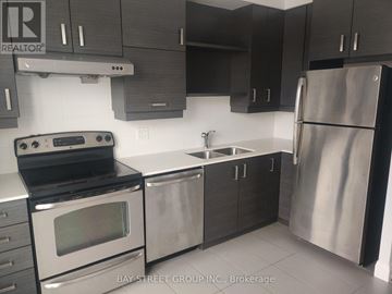 Markham (Unionville) condo for rent - A modern kitchen with a stainless steel refrigerator, oven, and sink.