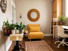 Brock (Beaverton) apartment for rent - A yellow chair sits in a room with a mirror and potted plants.