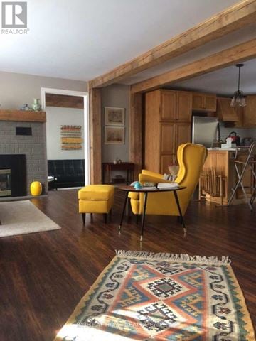 Brock (Beaverton) apartment for rent - A living room with a yellow chair and a rug.