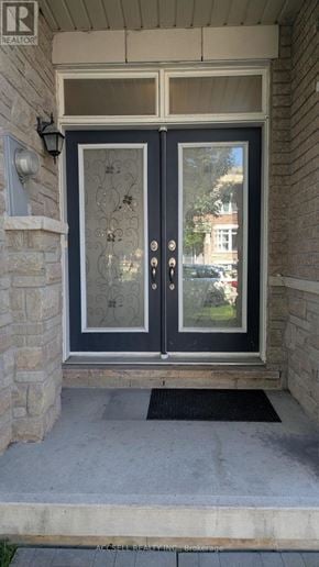 Markham (Village Green-South Unionville) townhouse for rent - A double door with glass panels and a metal handle.