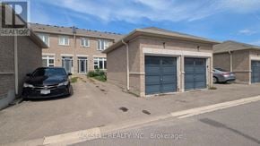Markham (Village Green-South Unionville) townhouse for rent - A black car is parked in front of a building with a sign that reads "ACCSELL REALTY INC, Brokerage".
