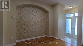 Markham (Village Green-South Unionville) townhouse for rent - A room with a floral wallpaper and a wooden floor.