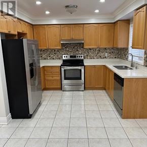 Brampton (Fletcher's Meadow) apartment for rent - A kitchen with wooden cabinets and a black refrigerator.