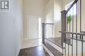 Blue Mountains apartment for rent - A hallway with a white door and a staircase with a black railing.