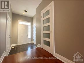Ottawa townhouse for rent - A hallway with a white door and a window.