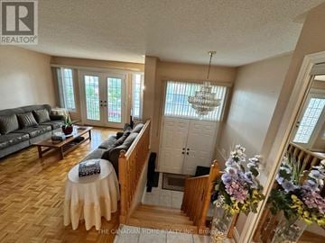 Vaughan (Maple) apartment for rent - A living room with a grey couch and a wooden table.