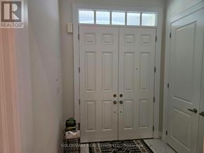 Richmond Hill (Oak Ridges Lake Wilcox) apartment for rent - A white door with a black handle and a small green plant on the side table.