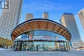 Vaughan (Vaughan Corporate Centre) condo for rent - A modern building with a curved wooden facade and glass windows, with the words "SMART VAMC" prominently displayed on the front.
