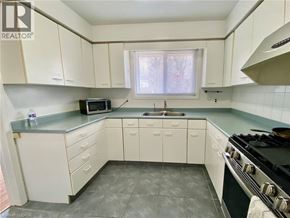 Waterloo apartment for rent - A kitchen with white cabinets and a black stove top.