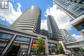 Markham (Grandview) condo for rent - A modern building with a curved facade stands tall among other buildings.